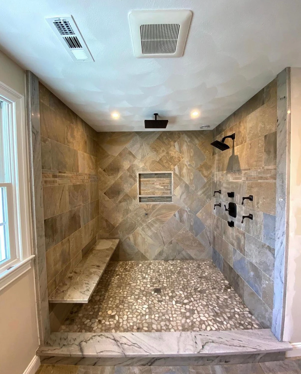 Custom tile shower with pebble floor