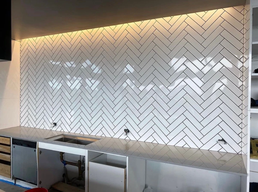 White herringbone subway tile kitchen backsplash