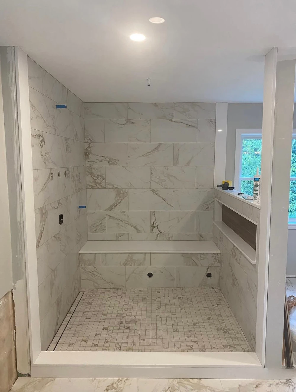 Marble-look tile shower build in progress