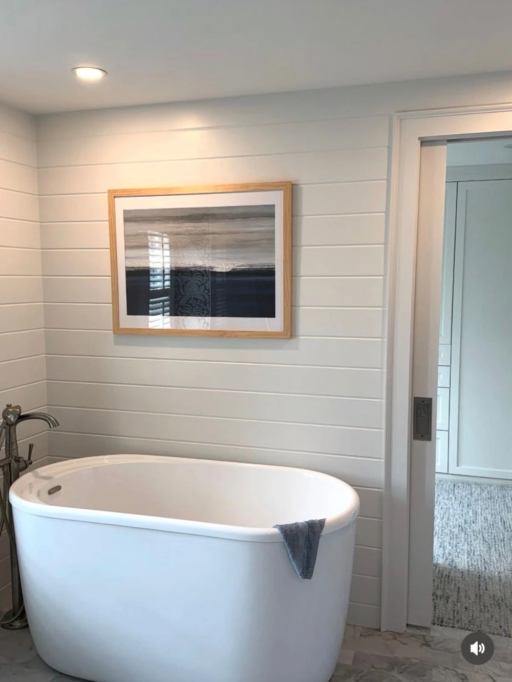 Freestanding soaking tub with shiplap wall